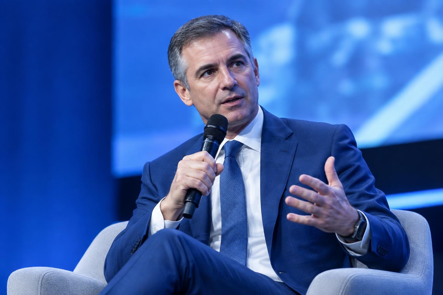 A regulator speaking on a conference stage
